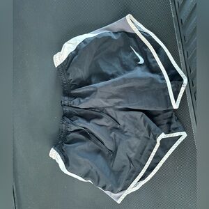 black lined nike shorts with gray and white on the sides